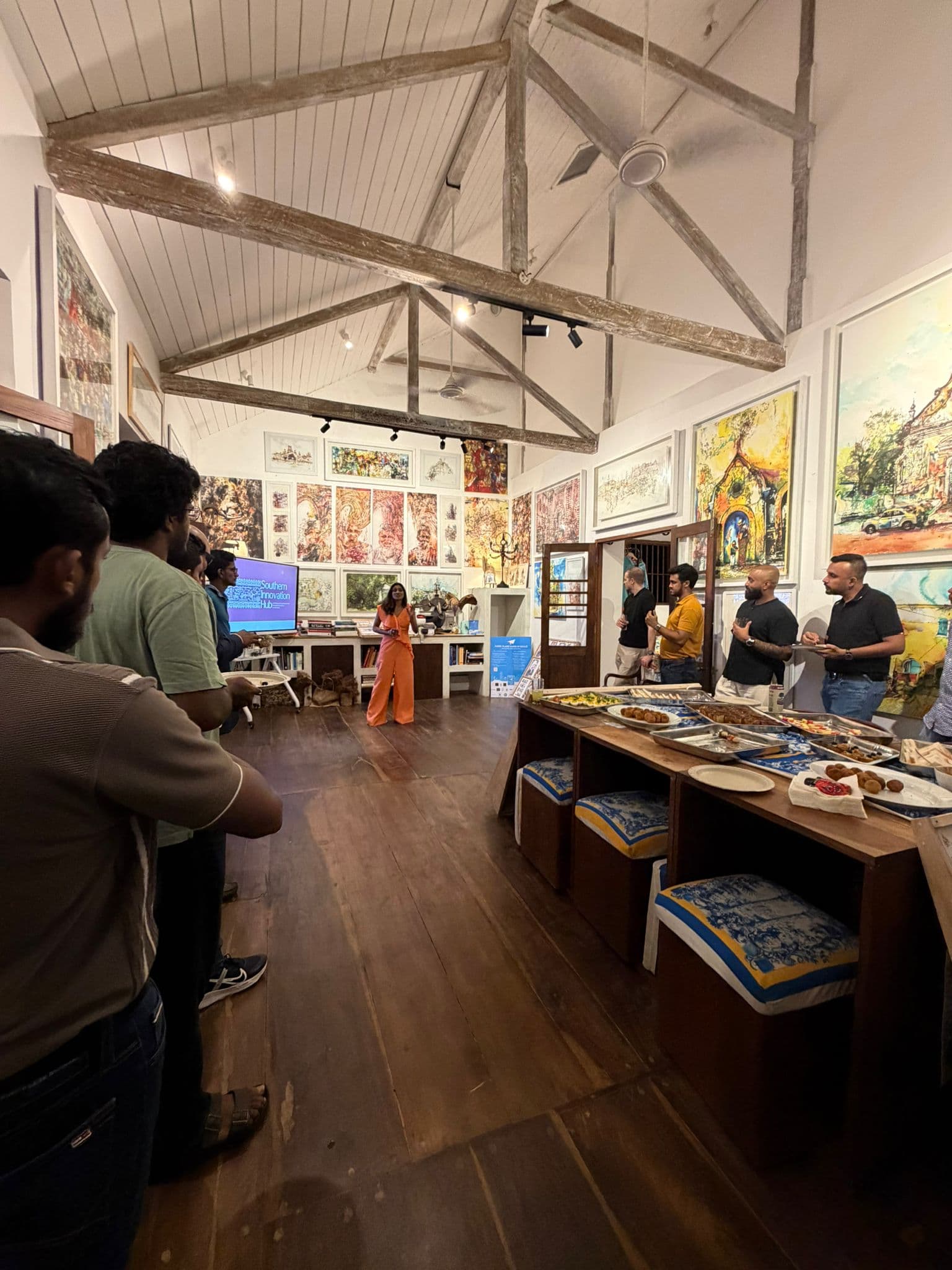 Founders gathered at a Southern Innovation Hub community event in a gallery